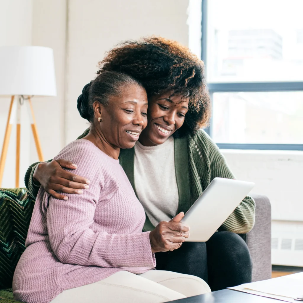 Older woman looking at a sheet of paper with younger woman